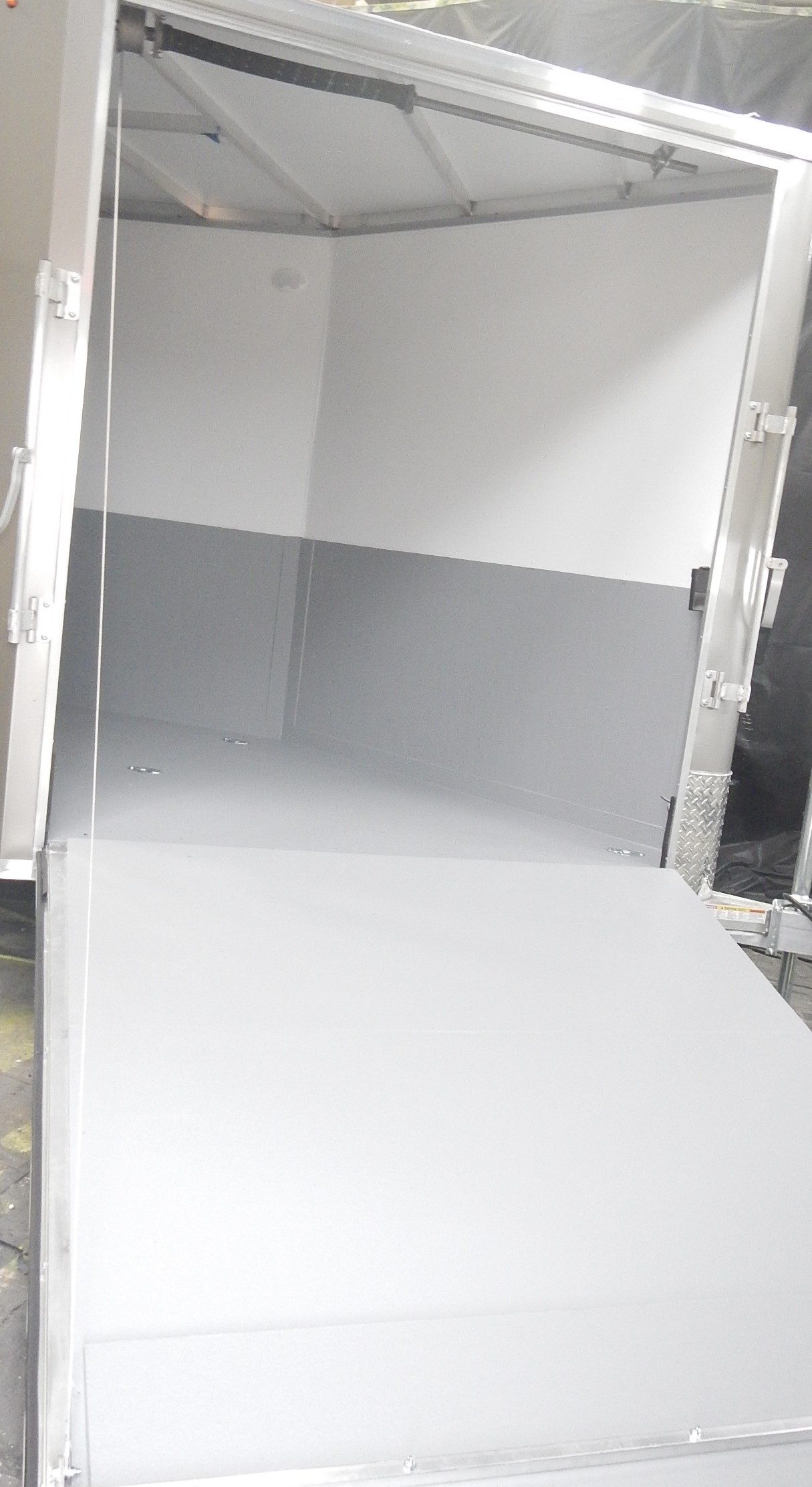 Camper, RV, trailer and mobile home inventory on a dealer lot receiving underbody coating